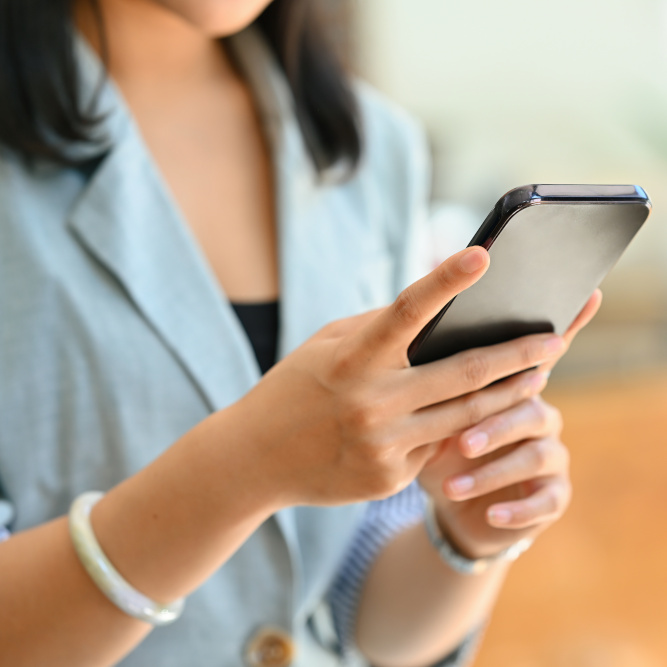Close up woman in the office using a smartphone, for business and technology concept.